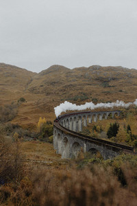 Smoke emitting from train on Glenfinnan Viaduct Scotland