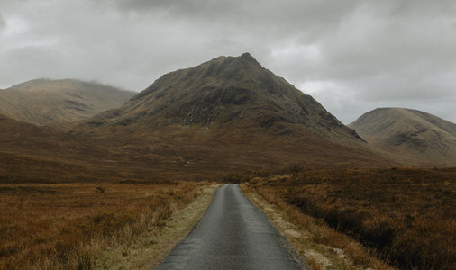 Road leading to rugged remote mountains FScotland