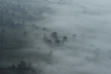 Ethereal fog over trees and landscape England