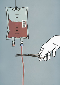 Hand with scissors cutting blood bag