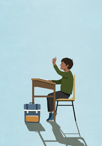 Schoolboy raising hand at classroom desk