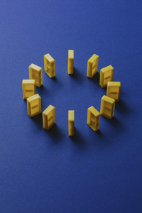 Yellow dominos forming European Union flag on blue background
