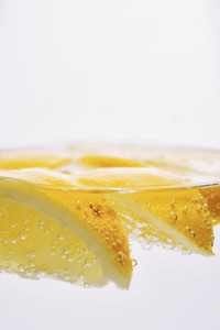 Close up lemon wedges in sparkling water