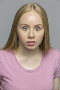 Portrait shocked wide eyed young woman