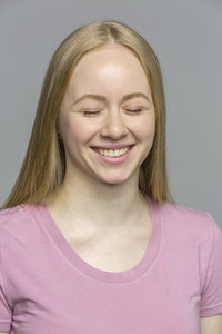 Portrait laughing young woman with eyes closed