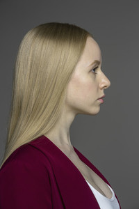 Profile portrait serious young woman with blonde hair