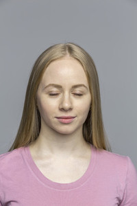 Serene young woman with eyes closed