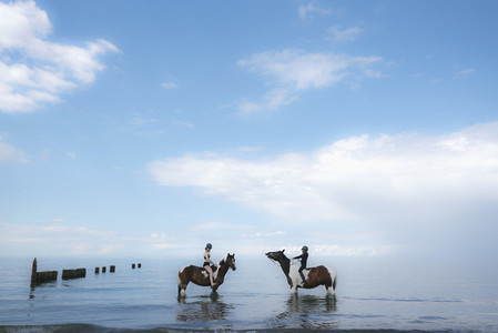 Girls riding horses in Baltic Sea Germany