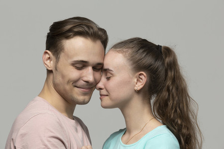 Studio portrait affectionate tender young couple