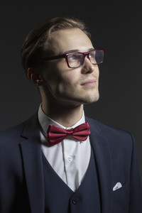 Portrait thoughtful handsome young man in suit and eyeglasses