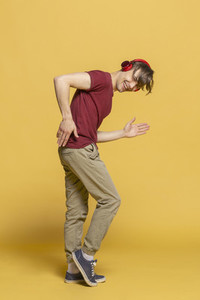 Portrait playful young man with headphones dancing