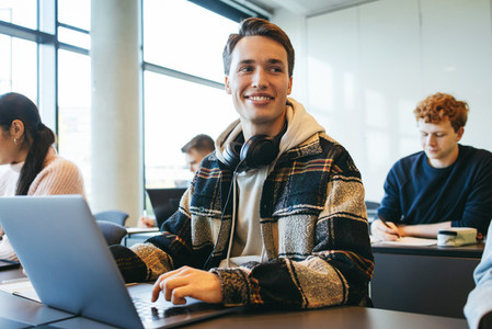 Student sitting in classroom with laptop