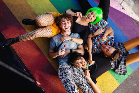 Carefree queer people lying down together
