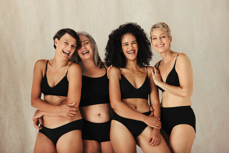 Happy women of different ages embracing their bodies
