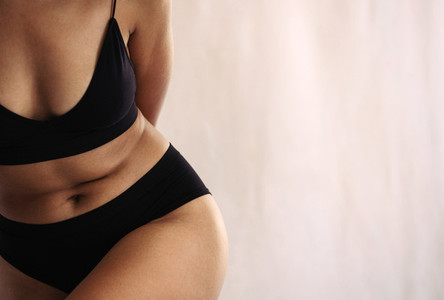 Shot of an anonymous natural female body in black underwear