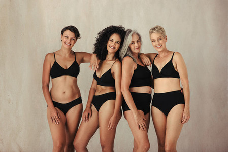 Four natural women of all ages celebrating their bodies