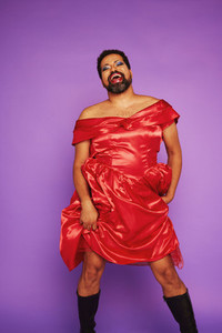 Gay man wearing makeup and red dress