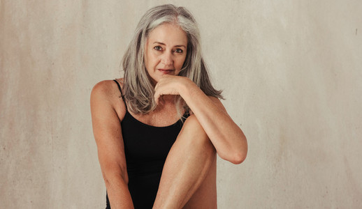Grey haired woman feeling confident in her natural body