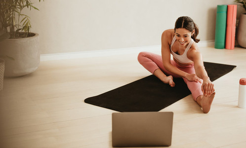 Female fitness instructor conducting online class