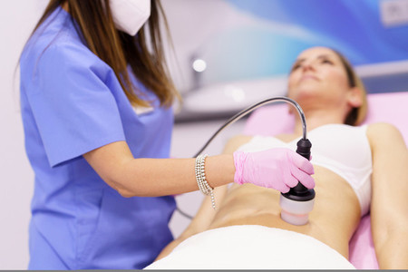 Woman receiving anti cellulite treatment with radiofrequency machine in an aesthetic clinic
