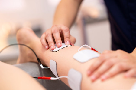 Electro stimulation in physical therapy to a young woman