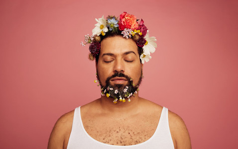 Gay man with flowers on head and beard