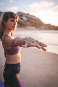 Woman performing warrior yoga pose