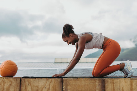 Fitness woman practicing yoga on rooftop