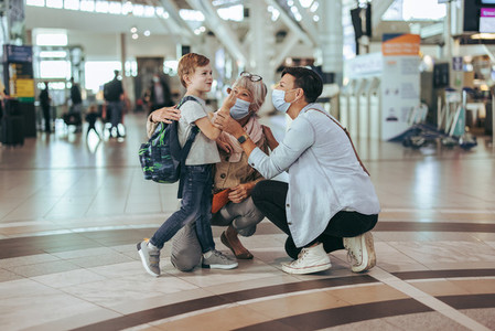 Family traveling by air waiting at airport during pandemic