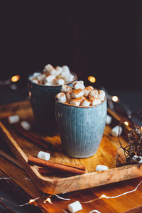 Hot chocolate with marshmallow and cinnamon in blue ceramic cups on a table  The concept of cosy holidays and New Year