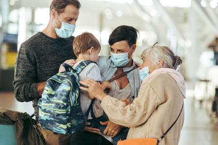 Grandma meeting family at airport post pandemic