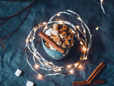 Hot chocolate with marshmallow and cinnamon in blue ceramic cups on a table  The concept of cosy holidays and New Year