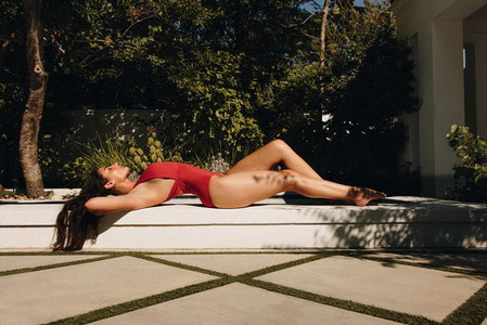Sensual young woman sunbathing at a resort
