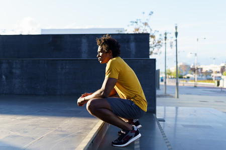 Black man with afro hair taking a break after workout