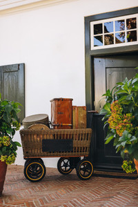 Still life of a trolley cart with travelling bags outside a hote