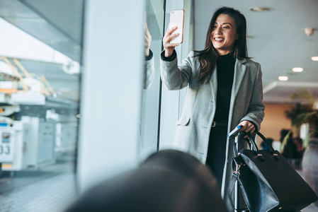 Woman in airport with phone