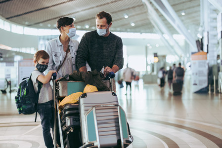 Family traveling at airport during pandemic