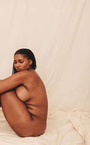 Nude woman sitting in a studio