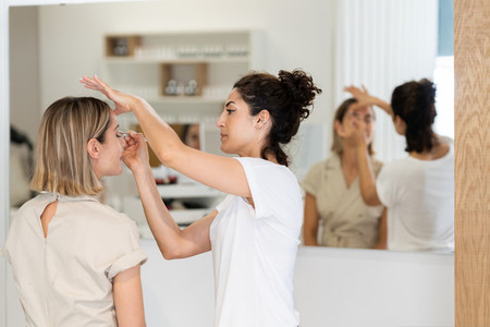 Arab makeup artist making up a woman in a beauty center