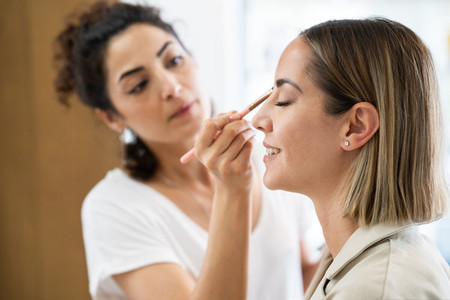 Arab makeup artist making up a woman in a beauty center