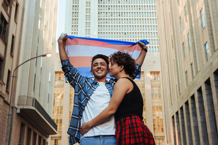 Gender nonconforming couple celebrating gay pride outdoors