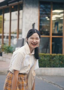 Happy young asian millennial woman smiling with braces in casual
