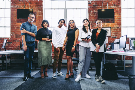 Diverse team of businesspeople standing together in an office