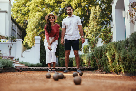 Couple playing petanque together