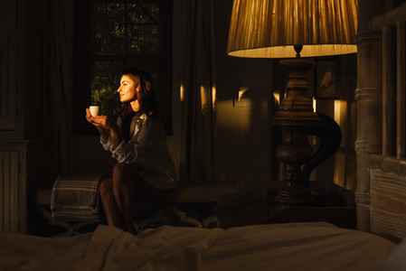 Serene young woman relaxing in her hotel room