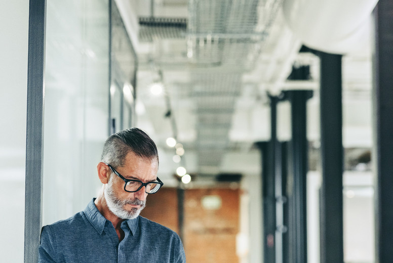 Mature businessman using a mobile phone in an office