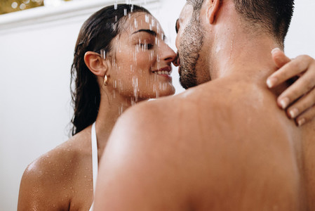 Lovers flirting under the shower