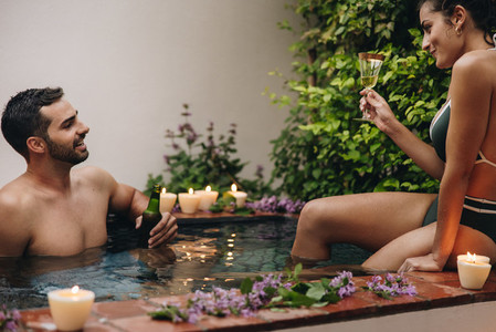Romantic young couple relaxing in a plunge pool
