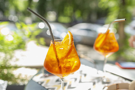 Orange cocktails with metal straws