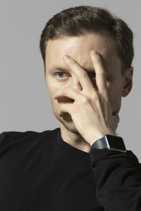 Portrait serious man with hand covering face